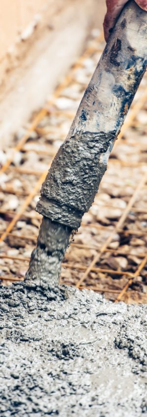 close up of industrial worker pouring cement or concrete with automatic pump tube